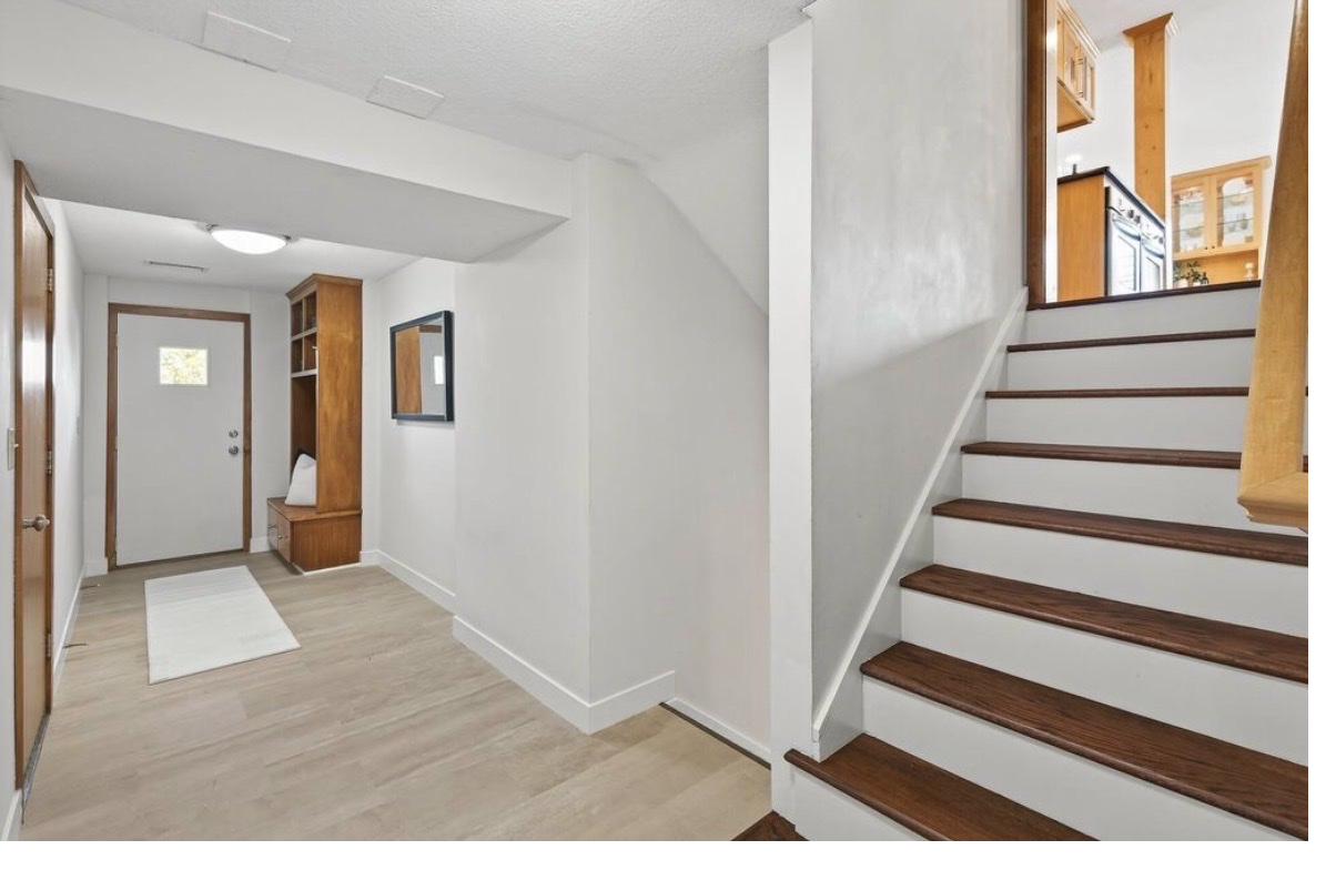 Edina mudroom and stairs after — new LVP, hardwood treads