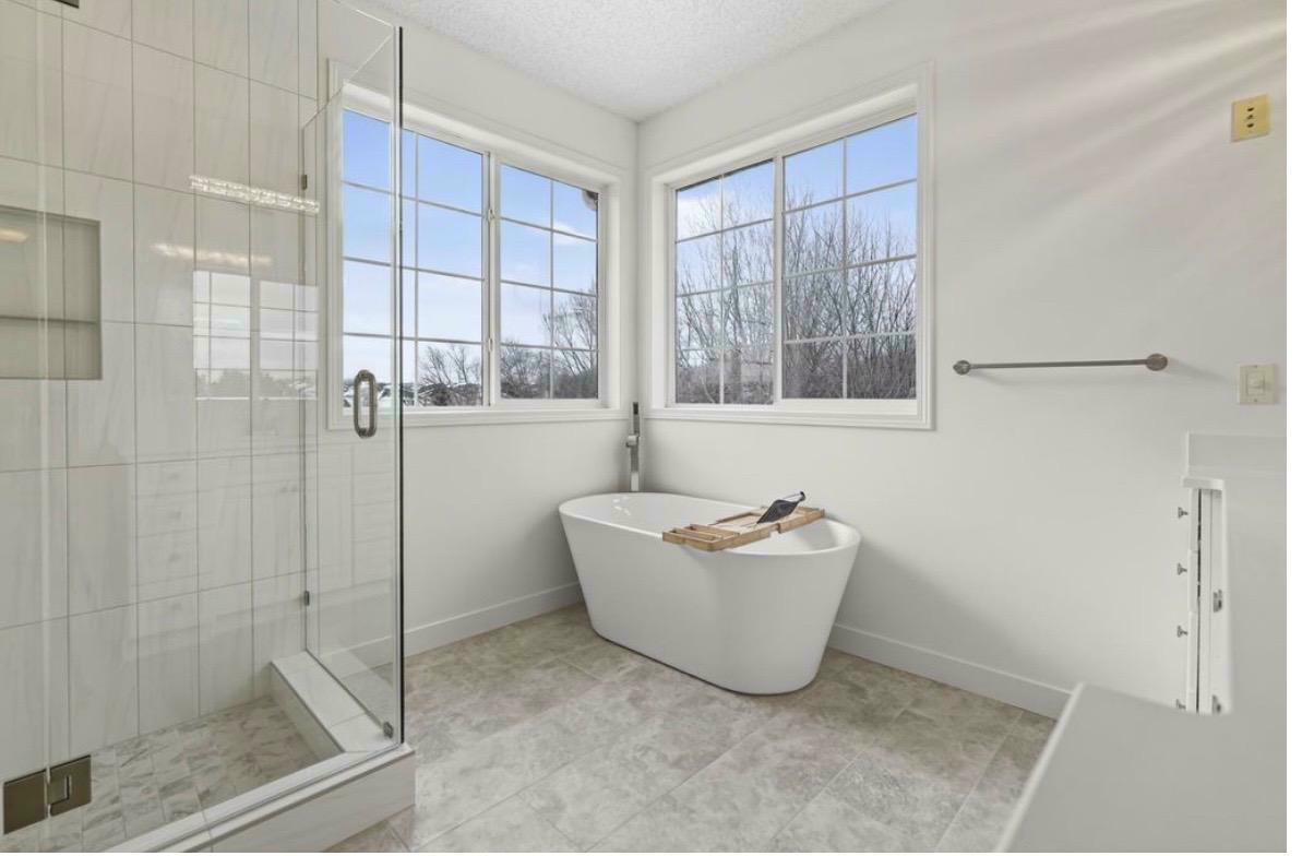 Highland Hills primary bath after — soaking tub, double vanity