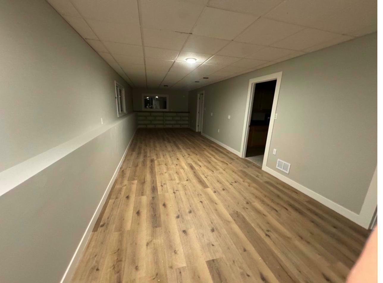Lower level after — LVP flooring, fresh paint