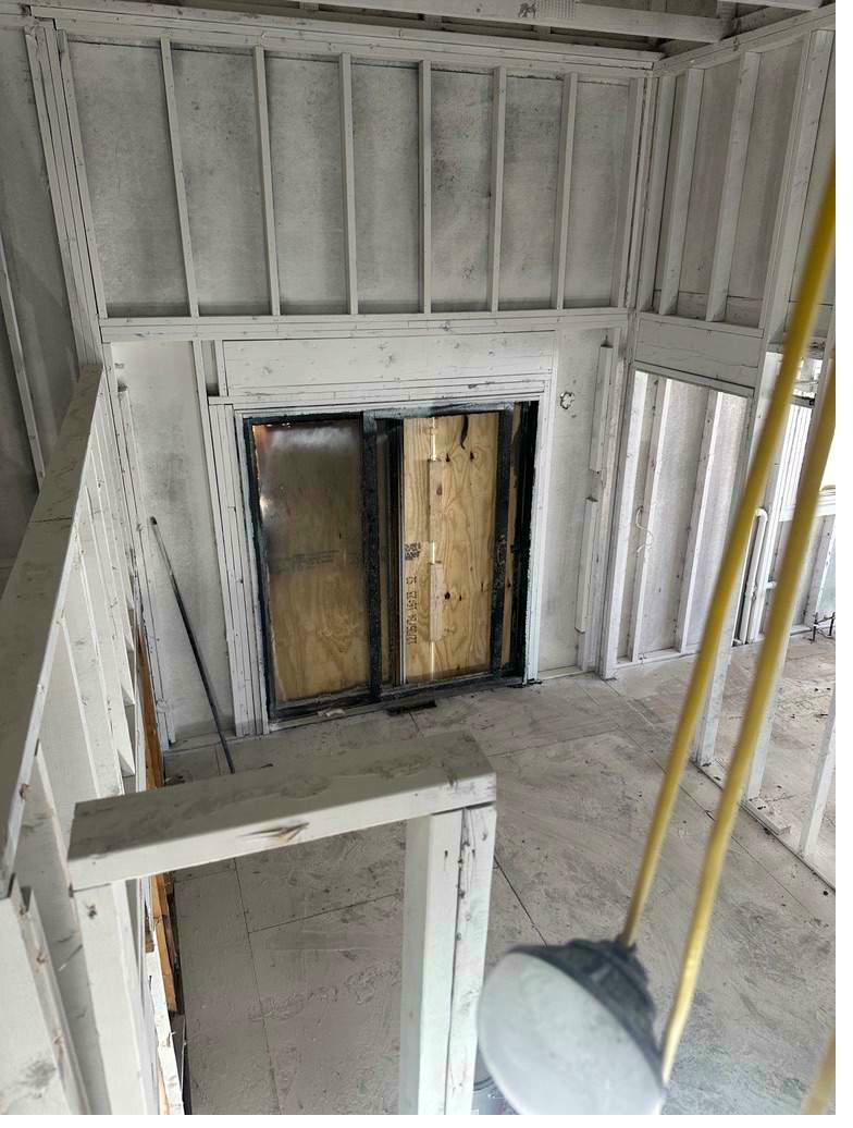 Fire damage reconstruction — stripped to framing, encapsulation phase