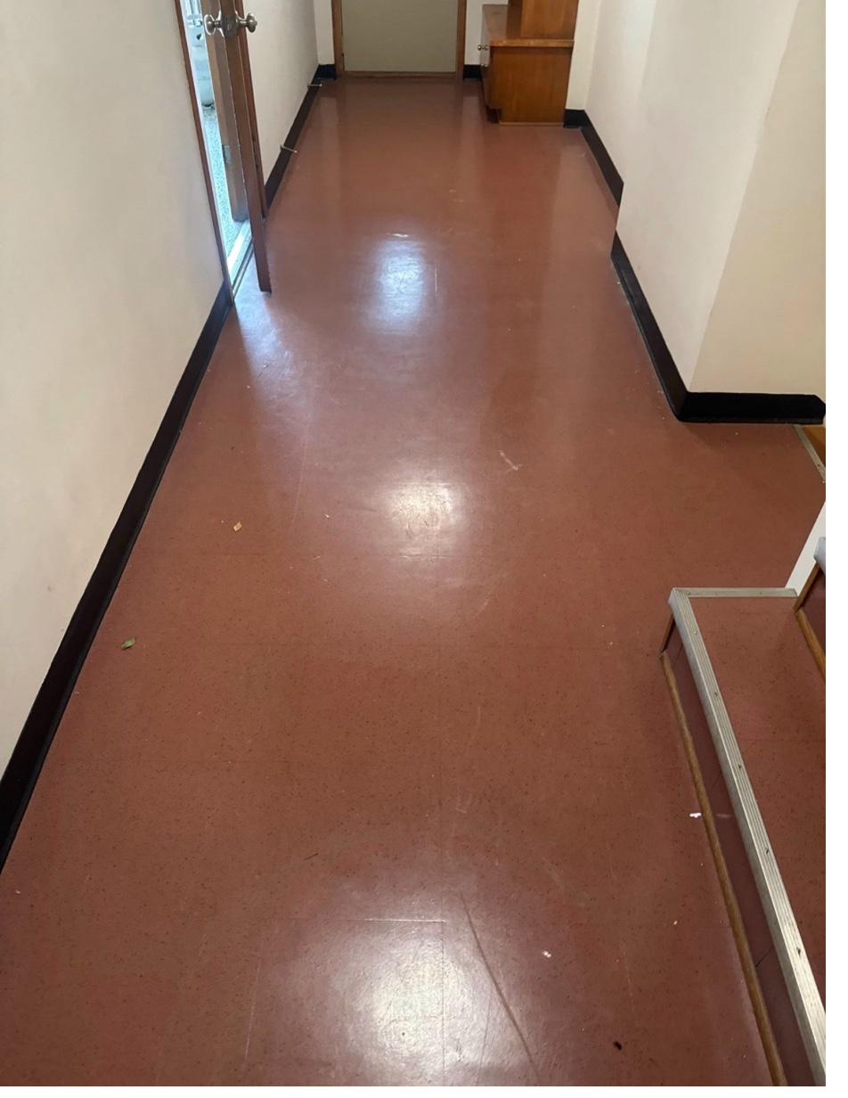 Edina hallway before — original red VCT flooring throughout