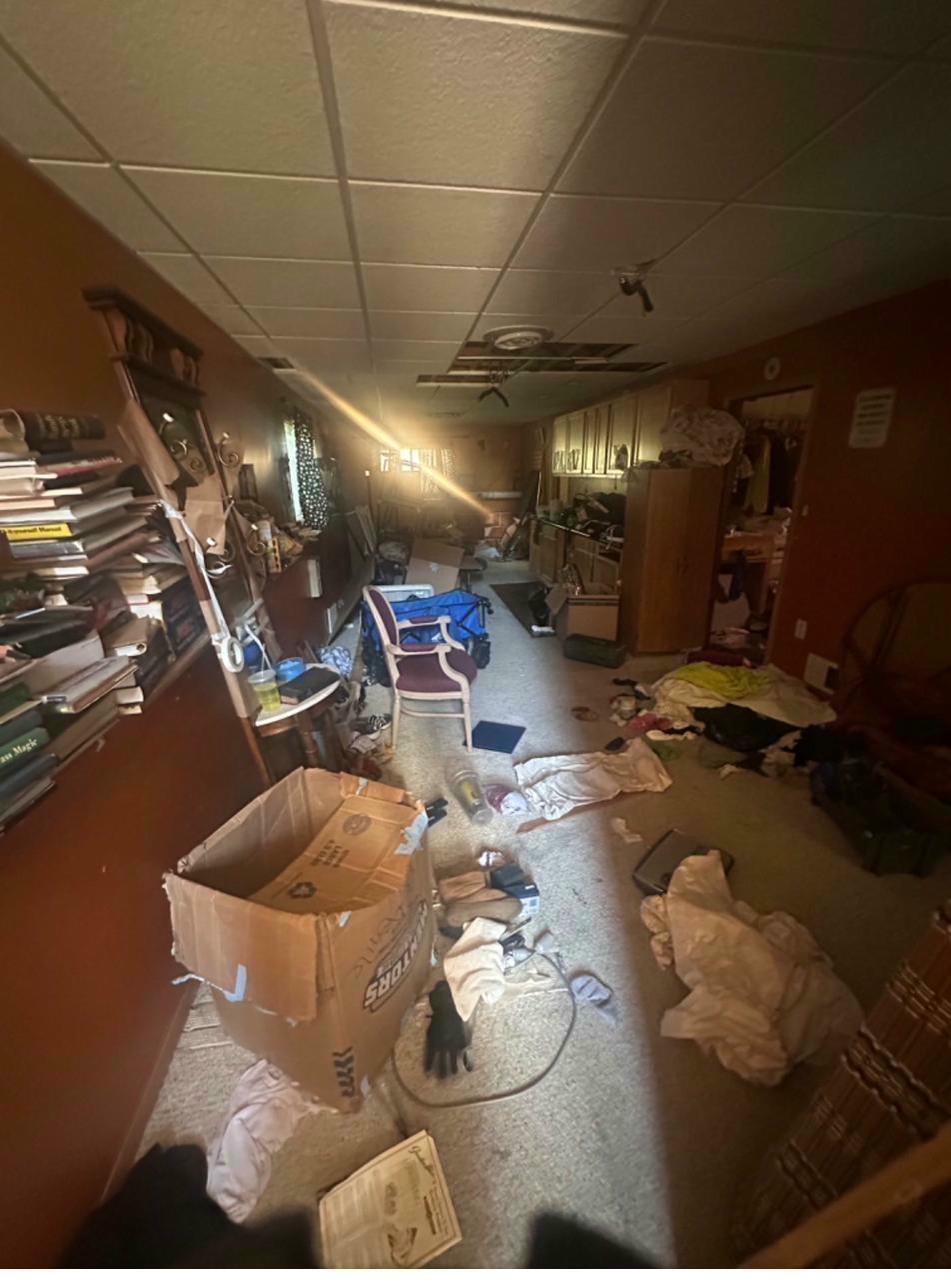 Lower level before — cluttered, dated finishes