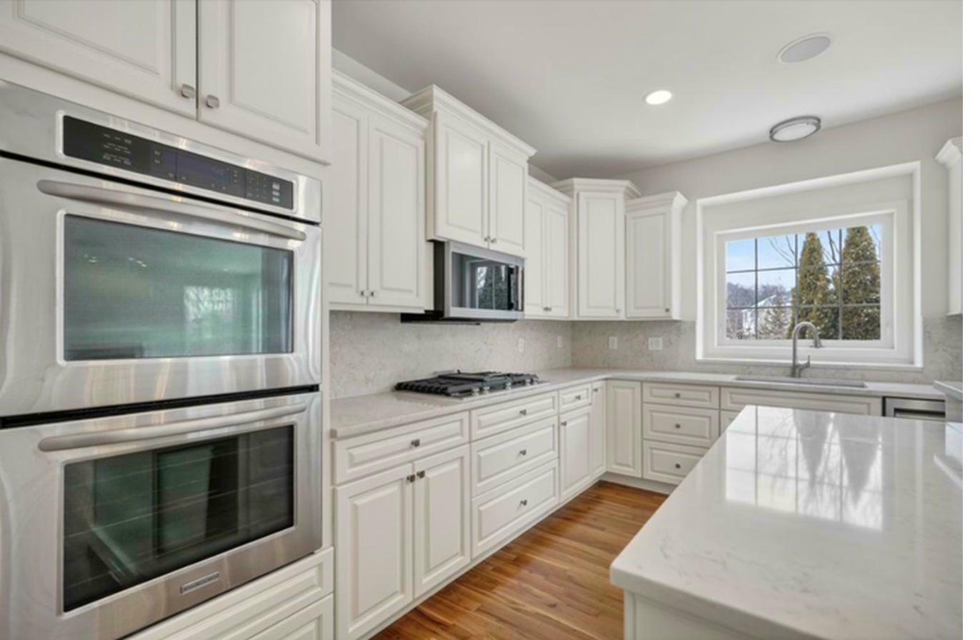 Kitchen — island, double ovens, hardwood floors
