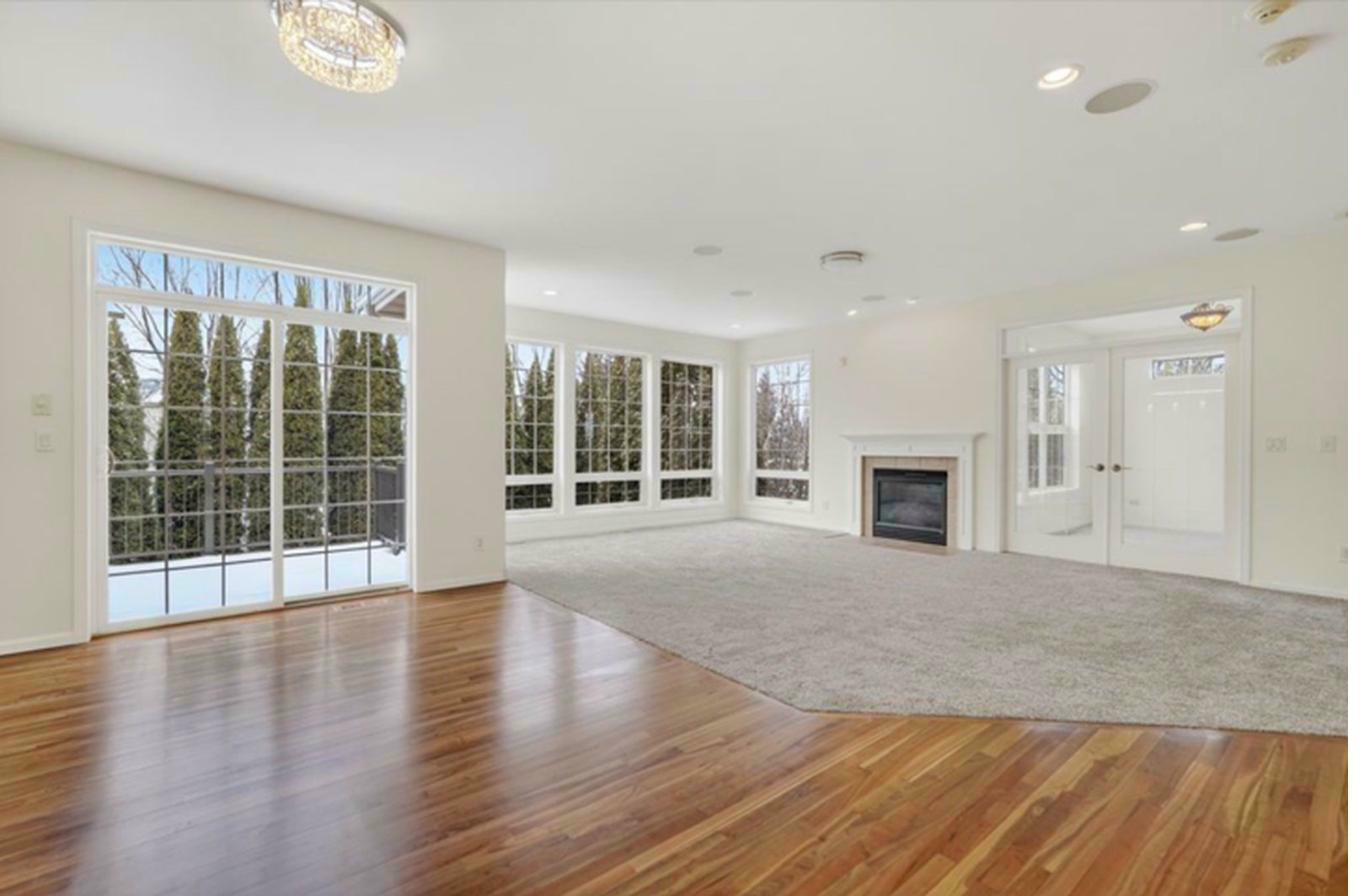 Main floor — hardwood floors, wall of windows, fireplace