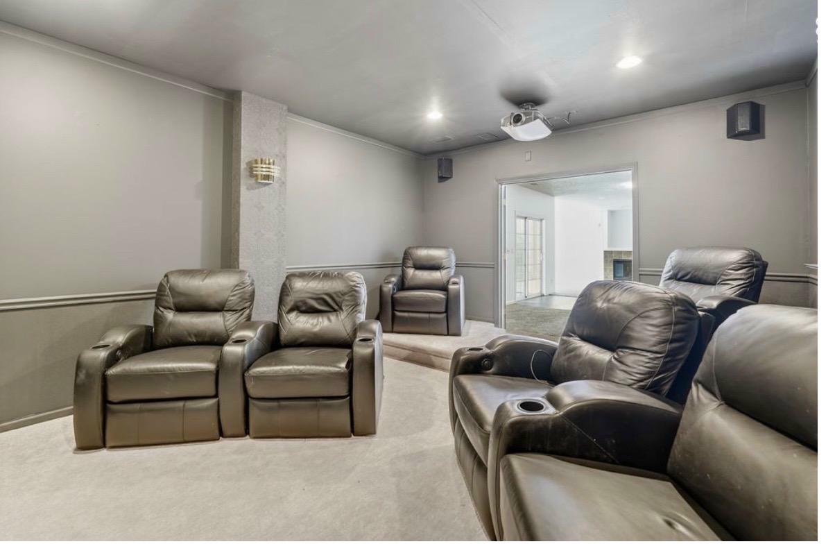 Home theatre after — facing the screen, recliners, acoustic panels