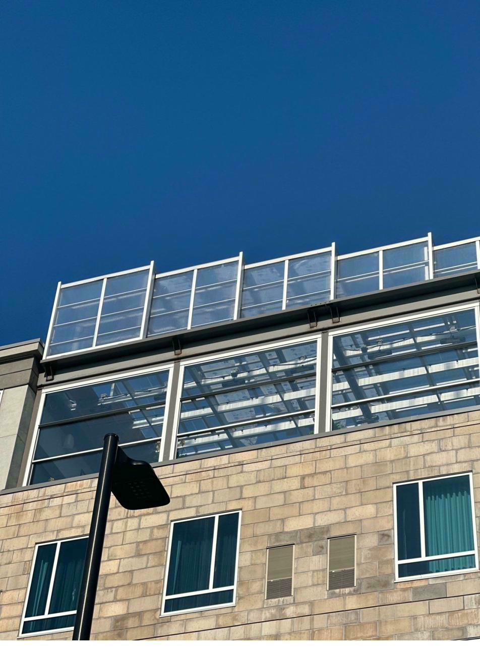 Hotel building — retractable roof panels and curtain wall