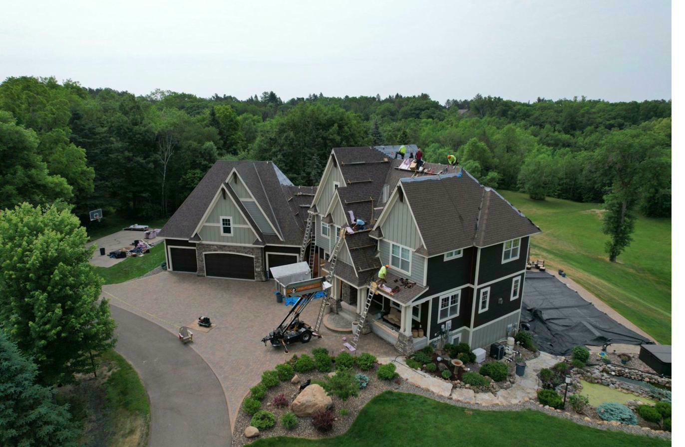 Aerial — active asphalt shingle installation