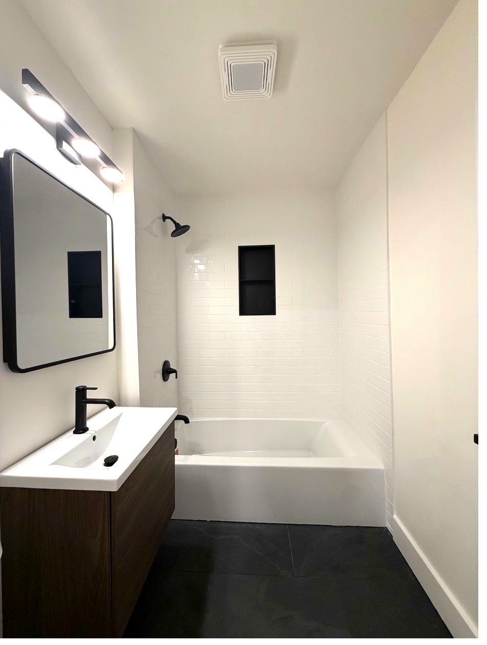 NE Minneapolis bath after — floating vanity, subway tile, slate floor