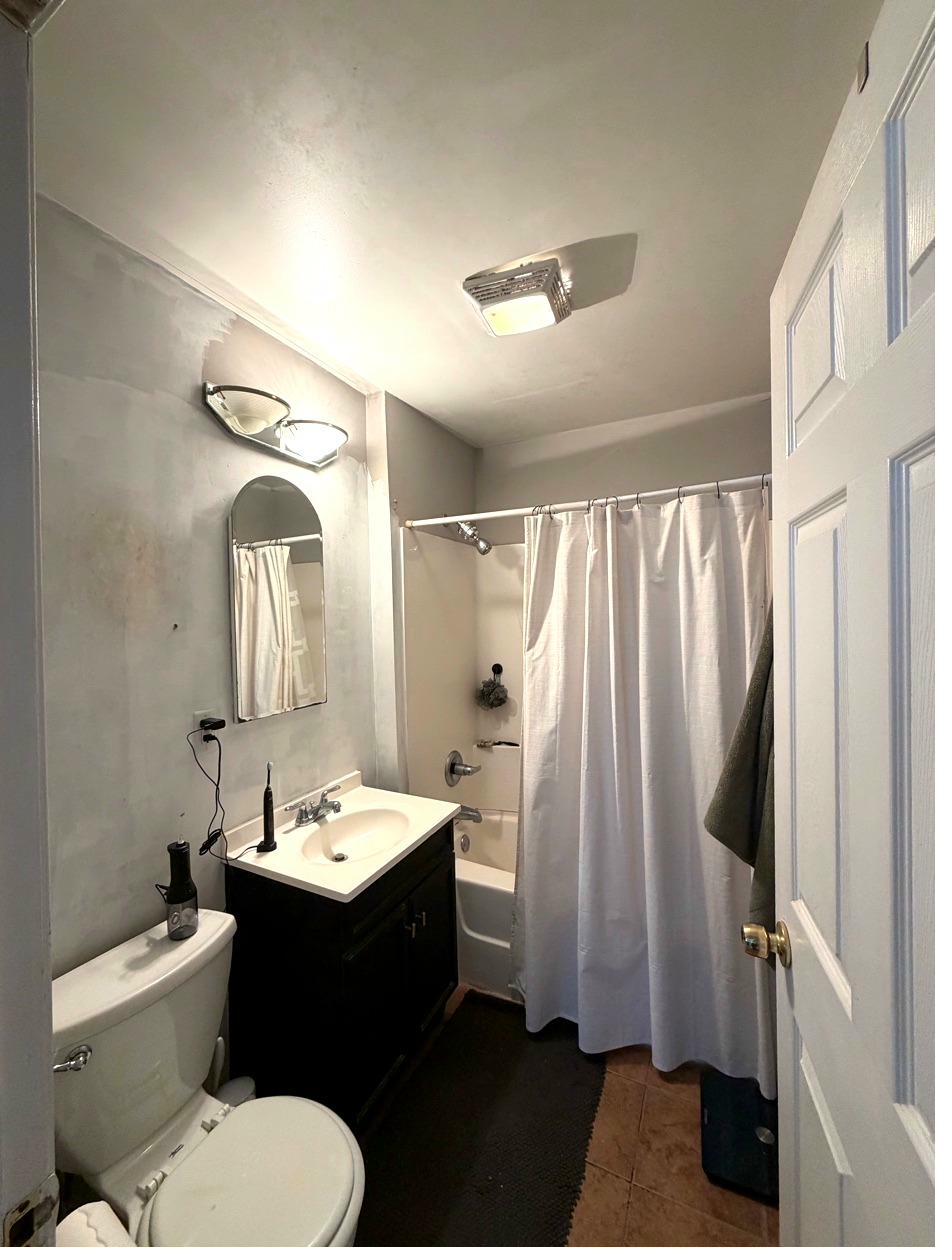 NE Minneapolis bath before — full room, dated finishes, shower curtain